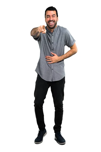 Handsome man pointing with finger at someone and laughing a lot — Stock Photo, Image