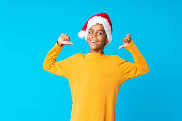 African American boy with christmas hat proud and self-satisfied