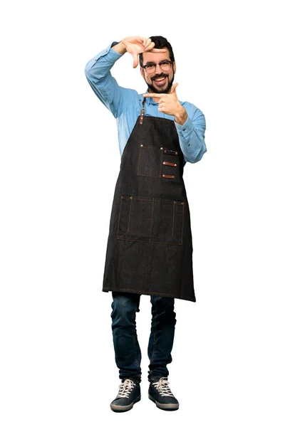 Full-length shot of Man with apron focusing face. Framing symbol over isolated white background