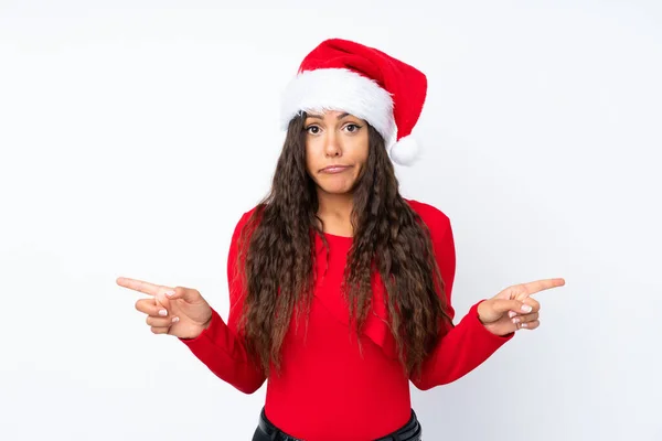 Girl Christmas Hat Isolated White Background Pointing Laterals Having Doubts — ストック写真
