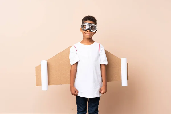 African American boy  with aviator hat and with wings over isolated background