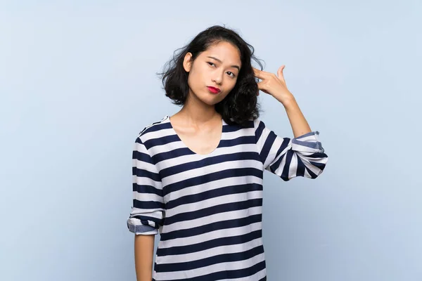 Asyalı Genç Bir Kadın Mavi Arka Planda Intihar Jesti Yapmada — Stok fotoğraf