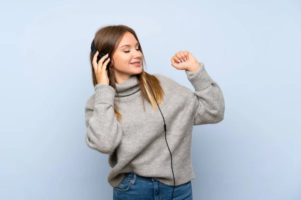 Teenager Girl Sweater Isolated Blue Background Listening Music Headphones — Stock Photo, Image