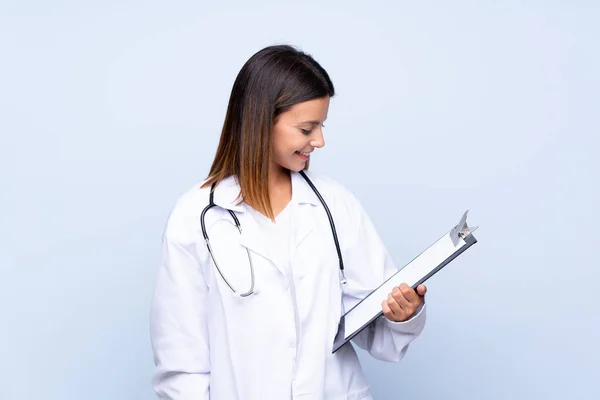Young Woman Isolated Blue Background Doctor Gown Holding Folder — Stock Photo, Image