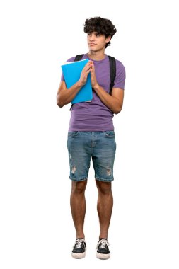 A full-length shot of a Young student man scheming something over isolated white background clipart