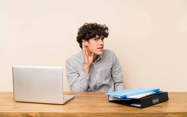 Joven Estudiante Con Portátil Escuchando Algo Poniendo Mano Oreja — Foto de Stock