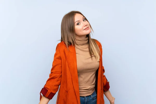 Tinédzser Lány Kabátot Több Mint Elszigetelt Kék Háttér Mosolyogva — Stock Fotó