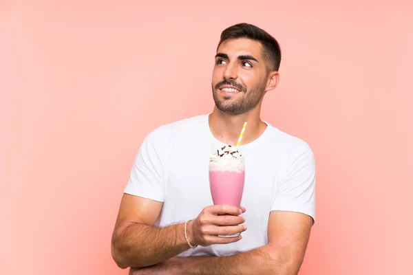 Young Man Strawberry Milkshake Isolated Pink Background Looking While Smiling — 스톡 사진