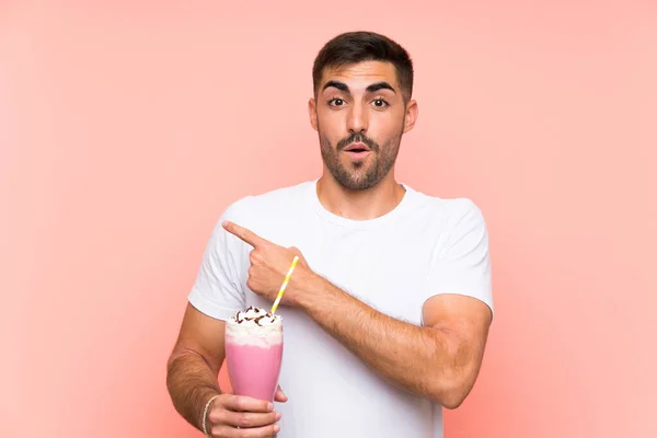 Young Man Strawberry Milkshake Isolated Pink Background Surprised Pointing Side — 스톡 사진