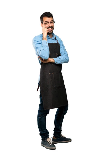Full-length shot of Man with apron with glasses and smiling over isolated white background