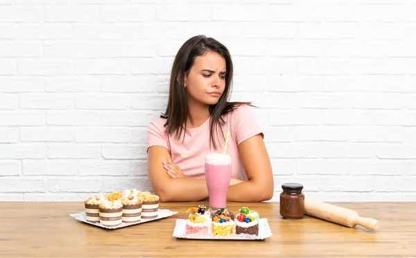 Young Girl Lots Different Mini Cakes Thinking Idea — Stock Photo, Image