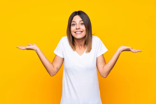 Young Woman Isolated Yellow Background Having Doubts While Raising Hands — Stock Photo, Image