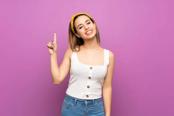 Pretty Young Woman Isolated Purple Wall Showing Lifting Finger Sign — Stock Photo, Image