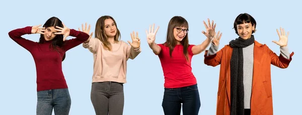 一组孤立的蓝色背景的女人用手指数着9 — 图库照片