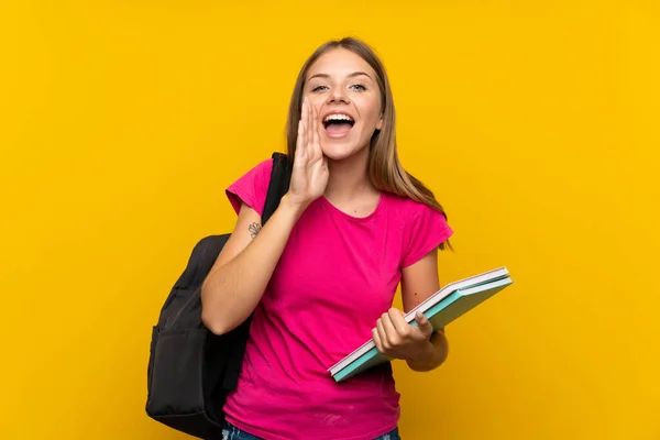 Joven Estudiante Chica Sobre Aislado Amarillo Fondo Gritando Con Boca —  Fotos de Stock