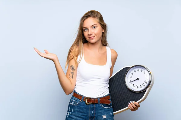 Young Blonde Girl Weighing Machine Isolated Blue White Background — Stock Photo, Image