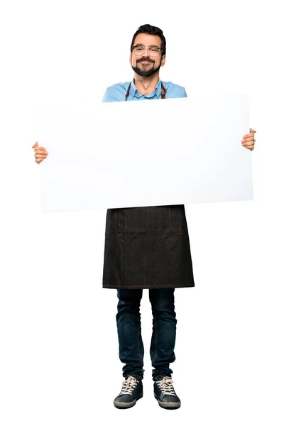 Full-length shot of Man with apron holding an empty placard over isolated white background
