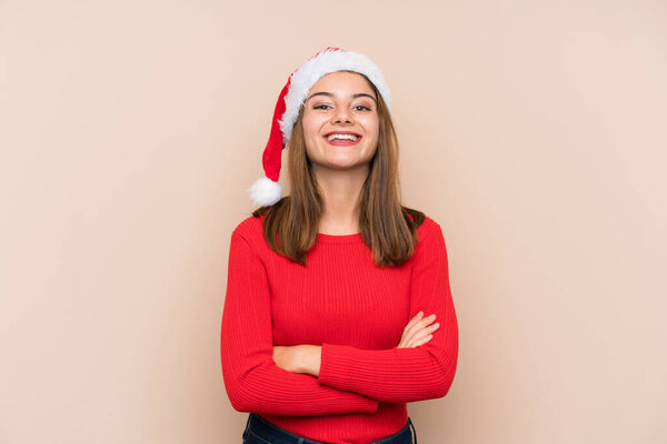 Young girl with christmas hat over isolated background laughing