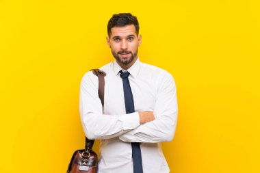 Izole sarı arka plan üzerinde Yakışıklı işadamı gülüyor