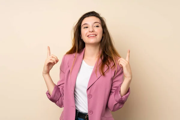 Chica Morena Joven Con Chaqueta Sobre Fondo Aislado Señalando Una —  Fotos de Stock