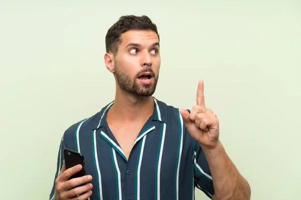 Young Handsome Man Mobile Intending Realizes Solution While Lifting Finger — Stock Photo, Image