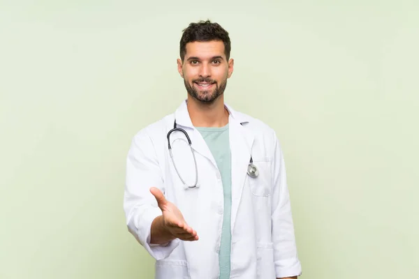 Young Doctor Man Isolated Green Wall Handshaking Good Deal — Stock Photo, Image
