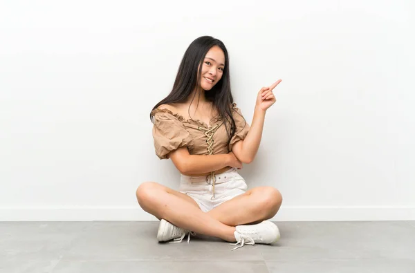Підліток Азіатська Дівчина Сидить Підлозі Вказуючи Палець Сторону — стокове фото