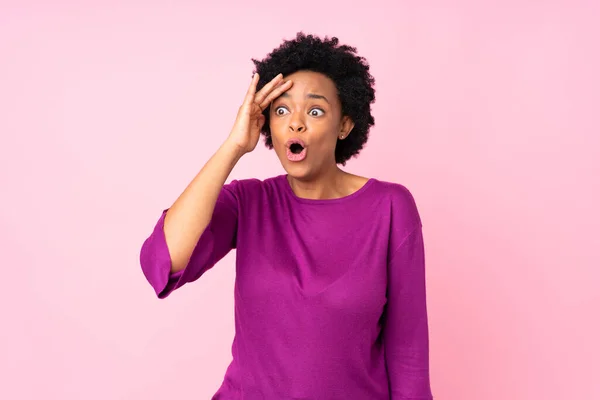 stock image African american woman over isolated pink background has just realized something and has intending the solution