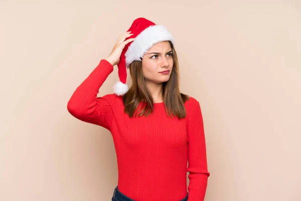 Menina Com Chapéu Natal Sobre Fundo Isolado Com Dúvidas Com — Fotografia de Stock