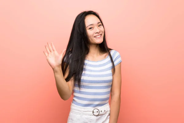 Adolescent Asiatique Fille Sur Isolé Rose Fond Saluant Avec Main — Photo