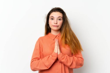 İzole edilmiş beyaz arka planda genç esmer kız avuç içlerini bir arada tutuyor. İnsan bir şey ister.