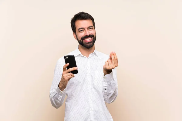 Elinde Cep Telefonu Olan Sakallı Genç Bir Adam Para Hareketi — Stok fotoğraf