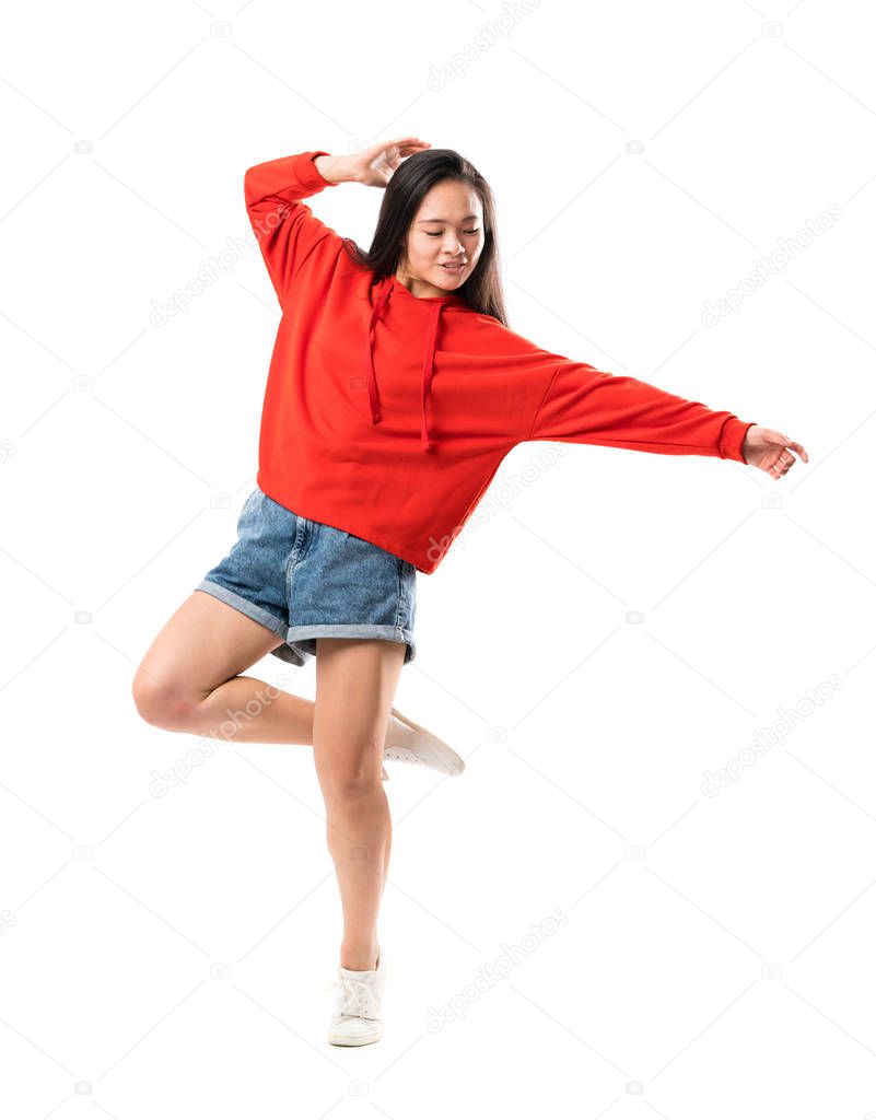 Young asian dancer over isolated white background