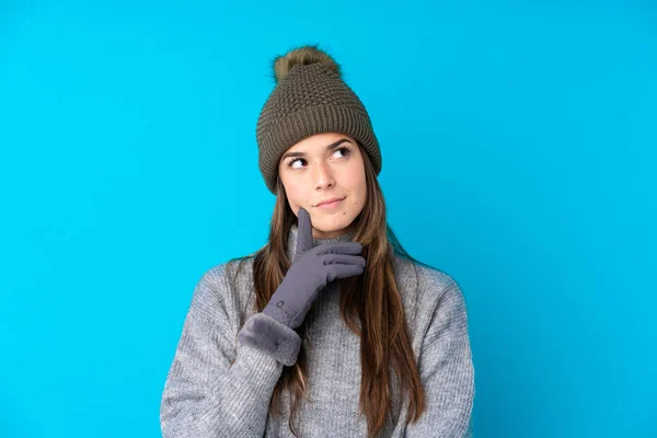 Ragazza Adolescente Con Cappello Invernale Sfondo Blu Isolato Pensando Idea — Foto Stock