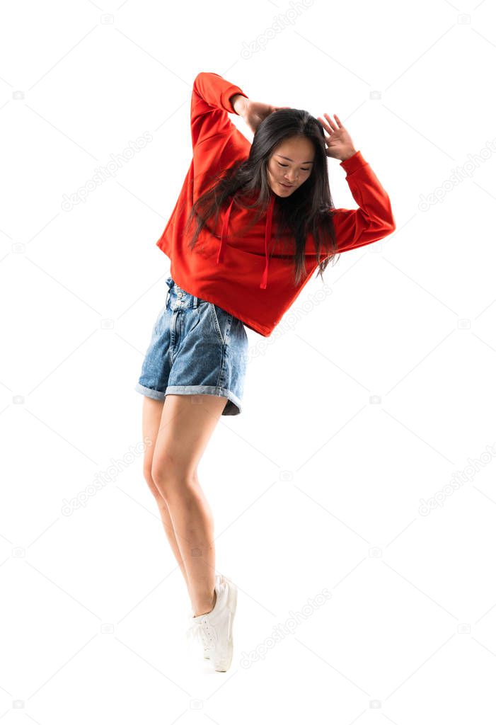 Young asian dancer over isolated white background