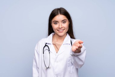 Doktor önlüğüyle izole edilmiş mavi bir geçmişi olan genç bir kadın anlaşma yapıyor.