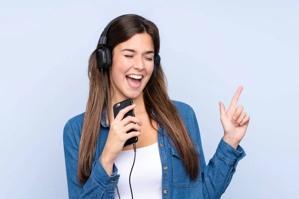 Adolescente menina brasileira ouvindo música e cantando sobre isolar — Fotografia de Stock