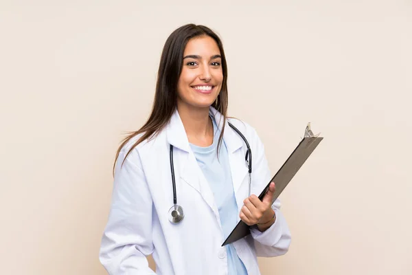 Young doctor woman over isolated background holding a folder — Stock Photo, Image