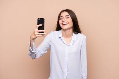 İzole arka plan üzerinde selfie yapan genç kadın