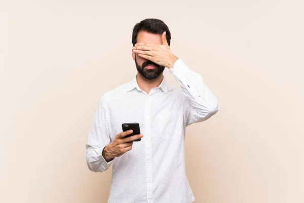 Young Man Beard Holding Mobile Covering Eyes Hands Want See — Stock Photo, Image