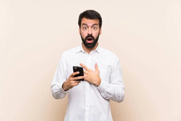 Young Man Beard Holding Mobile Surprised Shocked While Looking Right — Stock Photo, Image