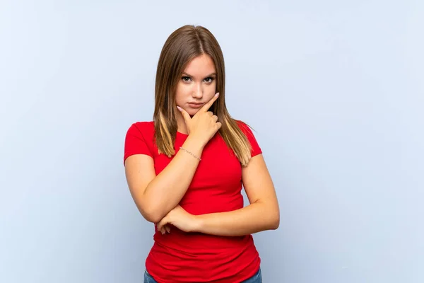 Adolescente Menina Sobre Isolado Fundo Azul Pensando Uma Ideia — Fotografia de Stock