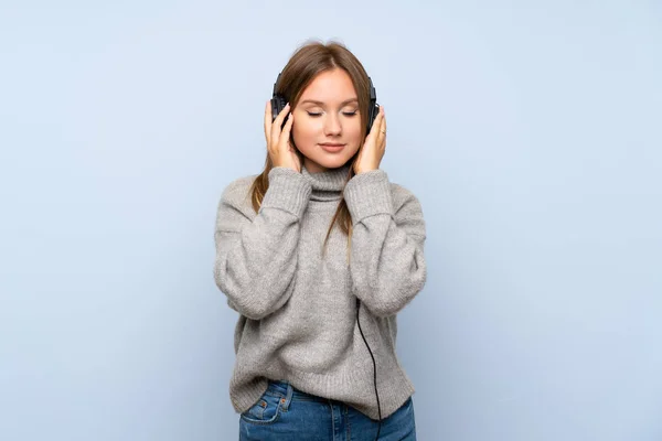 Teenager Girl Sweater Isolated Blue Background Listening Music Headphones — Stock Photo, Image