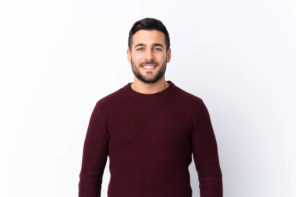 Sakallı, beyaz bir geçmişi olan genç ve yakışıklı bir adam kollarını ön cephede kavuşturuyor.