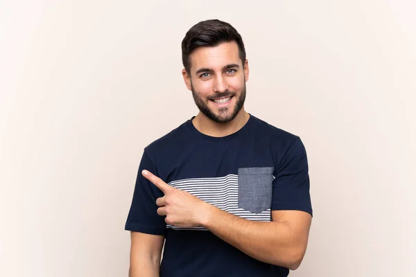 Joven Hombre Guapo Con Barba Sobre Fondo Aislado Apuntando Hacia —  Fotos de Stock