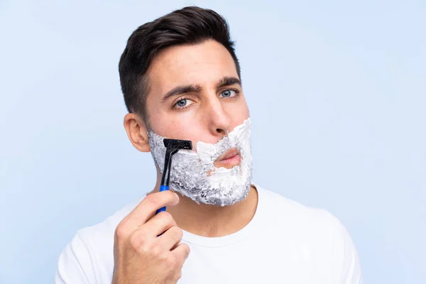 Young Handsome Man Shaving His Beard Isolated Background — Stock Photo, Image
