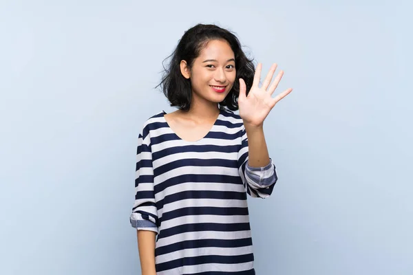 Asiática Joven Mujer Sobre Aislado Azul Fondo Contando Cinco Con —  Fotos de Stock