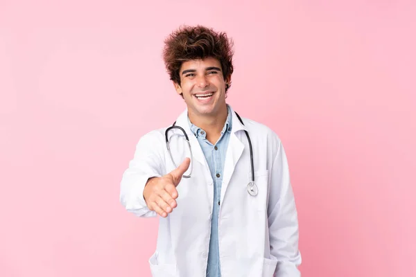 Joven Hombre Caucásico Sobre Fondo Rosa Aislado Con Bata Médico —  Fotos de Stock