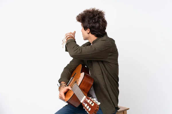 Jonge Blanke Man Met Gitaar Geïsoleerde Witte Achtergrond Wijzend Terug — Stockfoto