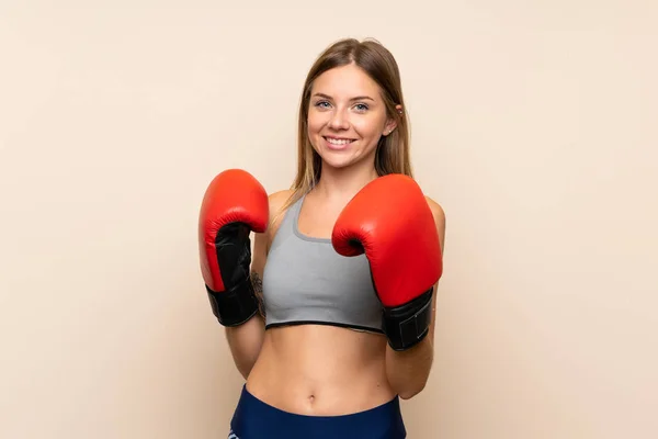 Young blonde girl with boxing gloves over isolated background — Stock Photo, Image